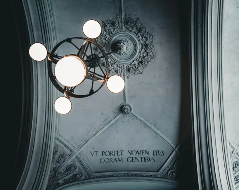 Ornate ceiling with a vintage chandelier and decorative molding. Elegant and classic design.